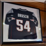 C01. Autographed Tedy Bruschi New England Patriots jersey in frame. 